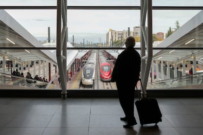 A traveler observes the trains from the Chamartín station in Madrid.