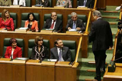 Atutxa conversa con el <i>lehendakari</i> en funciones, Juan José Ibarretxe, sentado en primera fila, en el salón de plenos del Parlamento vasco.