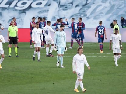 Courtois y sus compañeros salen del campo tras la derrota contra el Levante, que celebra al fondo.