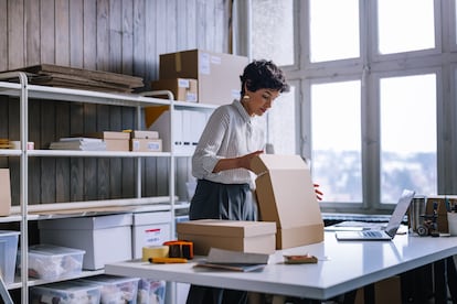 A Smart Businesswoman Preparing Packages For Shipping In Her Store