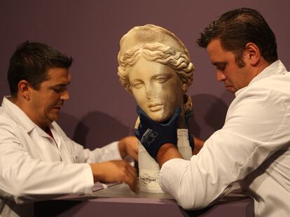 Dos operarios colocaban ayer la escultura de la diosa en el Museo Municipal de Santiponce Fernando Marmolejo.
