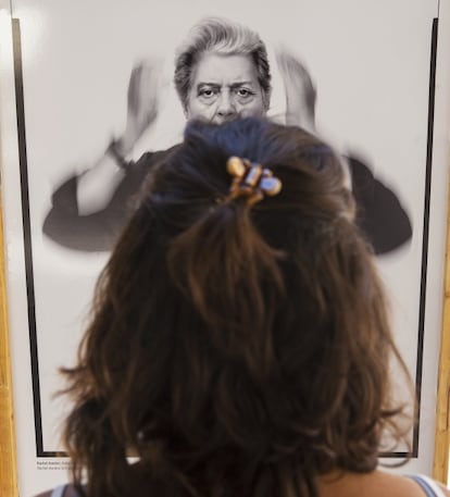 A passerby stops to look at a self-portrait of fashion photographer Richard Avedon.