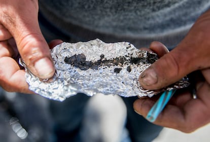 Roger Boyd, 35, holds a piece of foil containing Fentanyl while spending time on McAllister Street in the Tenderloin district of San Francisco, Calif. Friday, June 21, 2019.