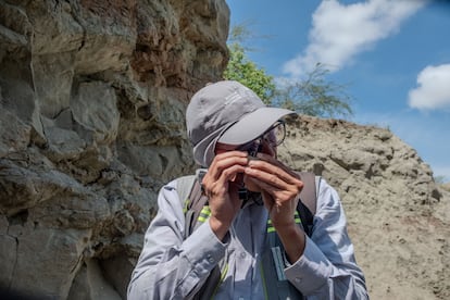 Luis Francisco Melo, del Servicio Geológico Colombiano, examina con lupa una roca para determinar su variedad, en el desierto de la Tatacoa.