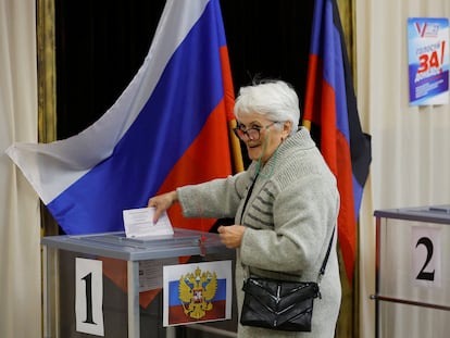 A voter casts her ballot at a polling station during local elections held by the Russian-installed authorities in the Donetsk region, Russian-controlled Ukraine, on Sept. 10, 2023.