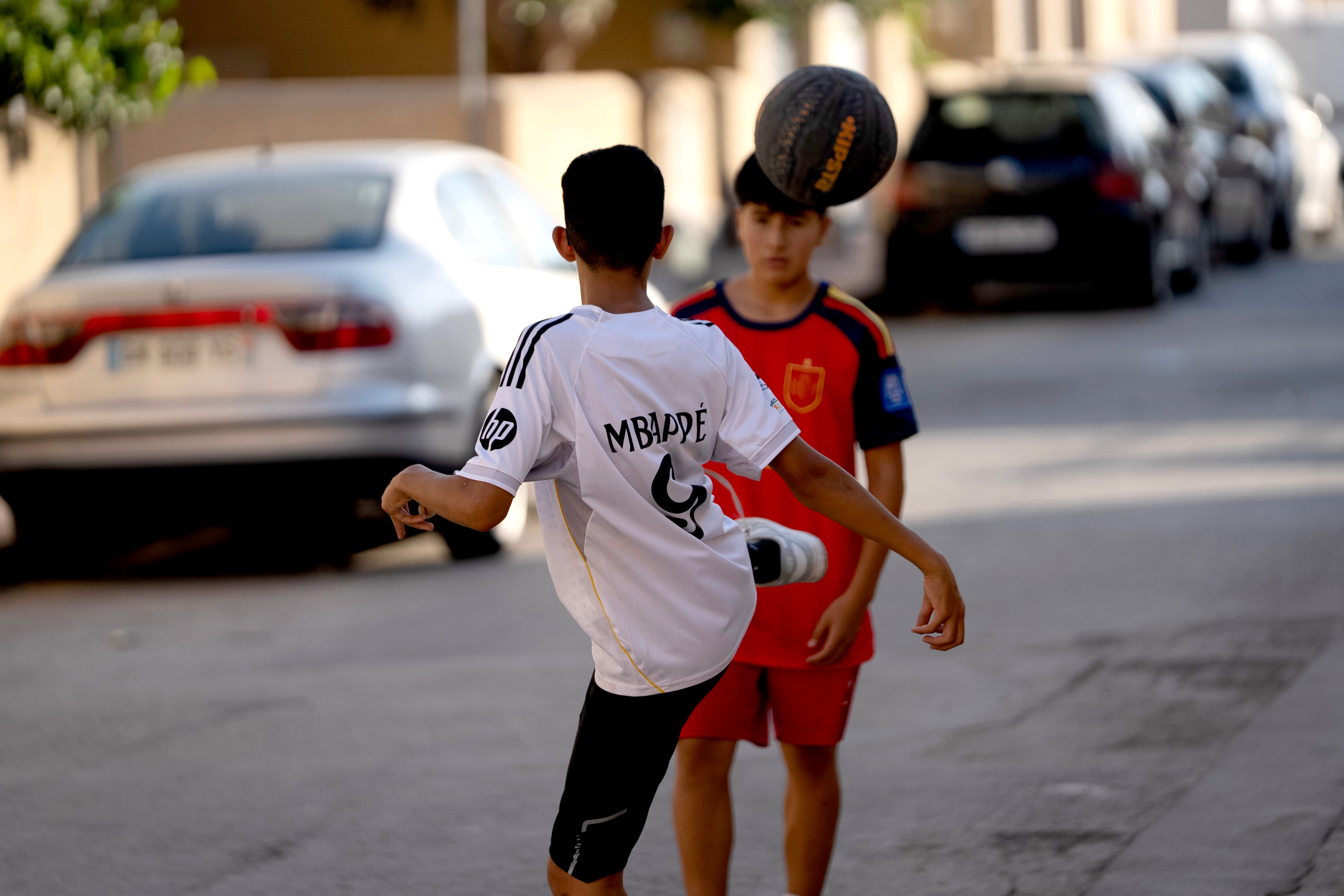 Two children play ball in the San Antonio neighborhood, in Torre Pacheco.