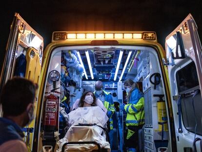 Health workers transport a patient in Madrid.