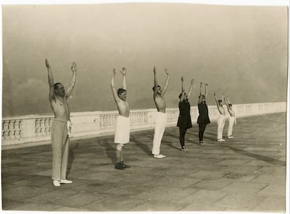 El rey Alfonso XIII y sus hijos hacen gimnasia en una terraza, posiblemente en el palacio de La Magdalena, Santander (ca. 1920). Imagen cedida por la editorial Galaxia Gutenberg e incluida en el libro 'El rey patriota. Alfonso XIII y la nación'.