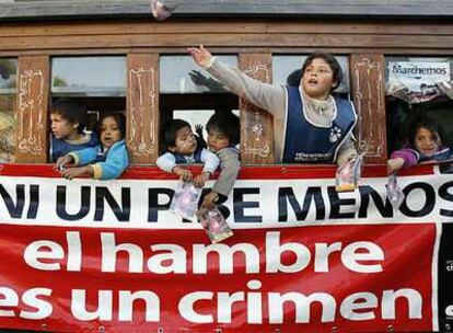 Un grupo de niños montados en un vagón de ferrocarril avanzan por el centro de Buenos Aires como parte de la marcha de los Chicos del Pueblo