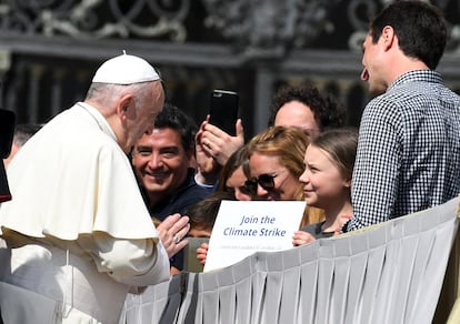 Pope Francis speaks with activist Greta Thunberg in St. Peter's Square at the Vatican on April 17, 2019.