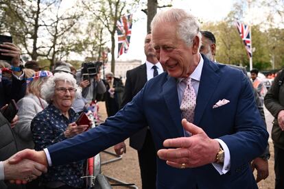 King Charles III greets citizens gathered near Buckingham Palace in London.