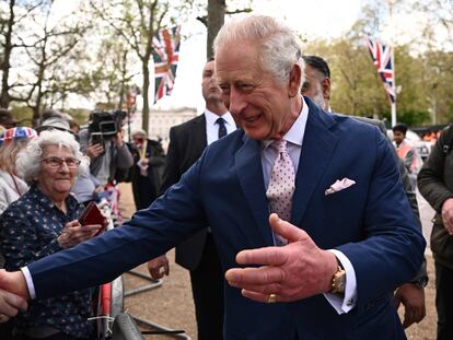 King Charles III greets citizens gathered near Buckingham Palace in London.