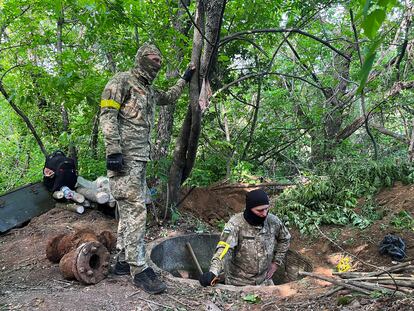 Miembros de la brigadas de defensa territorial cavan trincheras y construyen defensas en el frente de Donbás, este martes.