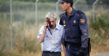 El maquinista, momentos después del accidente, conducido por un policía.