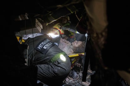 Una mujer tras ser rescatada entre los escombros de un edificio bombardeado en Kiev, este jueves. 