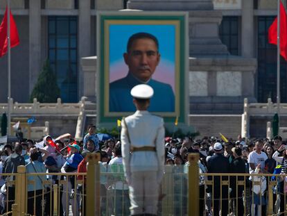 Visitors gather near a portrait of Sun Yat-sen, who is widely regarded as the founding father of modern China, at Tiananmen Square during the May Day holiday period in Beijing, Sunday, April 30, 2023.