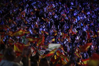 People wave Spanish flags during a Vox rally in Madrid.