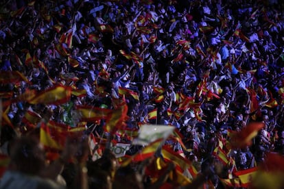 People wave Spanish flags during a Vox rally in Madrid.