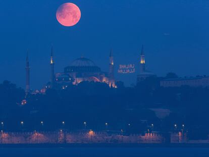 A full moon rises above the iconic Haghia Sophia in Istanbul, Turkey, early Monday, May 16, 2022. (AP Photo/Mucahid Yapici)