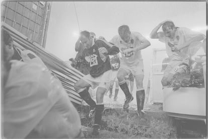 Los jugadores del Valencia y del Deportivo corren hacia el túnel de vestuarios del Bernabéu para refugiarse de la tormenta.