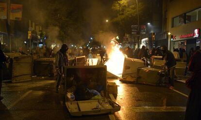Los manifestantes contra el cierre del centro 'okupado' de Can Vies forman una barrera con contenedores, algunos de ellos en llamas.