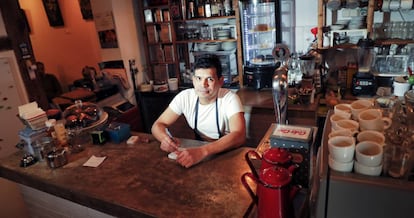 Julio Grisales works long hours at his Madrid coffee bar.