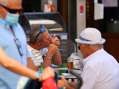 Personas fumando en terrazas y vías públicas en Málaga.