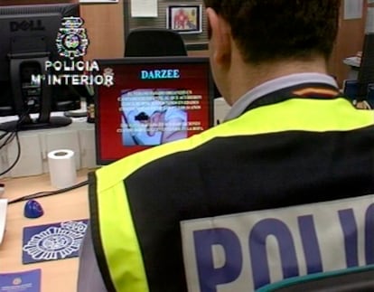 An officer from the Technology Investigation Brigade analyzes seized child pornography material .