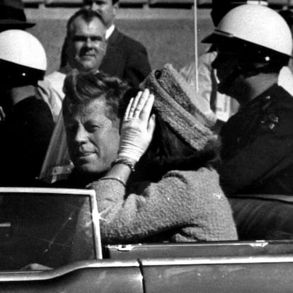 FILE - President John F. Kennedy waves from his car in a motorcade approximately one minute before he was shot, Nov. 22, 1963, in Dallas. Riding with President Kennedy are first lady Jacqueline Kennedy, right, Nellie Connally, second from left, and her husband, Texas Gov. John Connally, far left. (AP Photo/Jim Altgens, File)