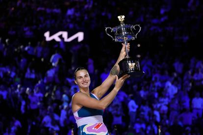 Aryna Sabalenka of Belarus holds the Daphne Akhurst Memorial Trophy aloft after defeating Elena Rybakina of Kazakhstan in the women's singles final at the Australian Open tennis championship.