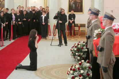 La hija de la pareja presidencial polaca reza ante los féretros de sus padres, ayer en Varsovia.
