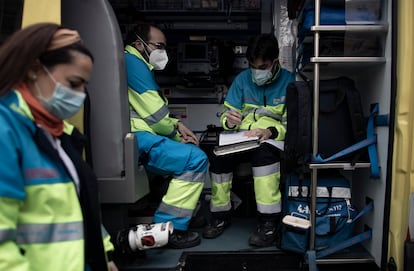 Varios trabajadores sanitarios de una UVI móvil del SUMMA 112 hacen anotaciones durante su jornada de trabajo el pasado viernes en Madrid.