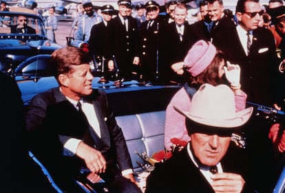 Texas Governor John Connally adjusts his tie (foreground) as US President John F Kennedy (left) & First Lady Jacqueline Kennedy