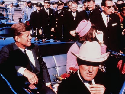 Texas Governor John Connally adjusts his tie (foreground) as US President John F Kennedy (left) & First Lady Jacqueline Kennedy