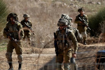 Israeli troops move on the Syrian side of the border near the Druze village of Majdal Shams, in the Israeli-annexed Golan Heights, December 9, 2024. 
