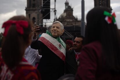 Un hombre que lleva una máscara del rostro del presidente.