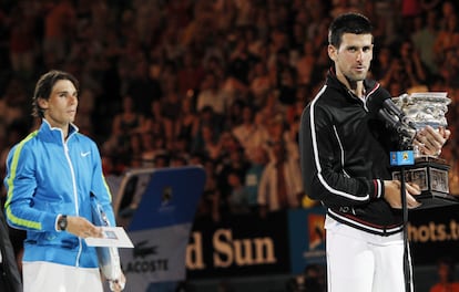 Novak Djokovic y Rafael Nadal sostienen sus respectivos trofeos después de la final del Abierto de Australia, el 29 de enero de 2012.