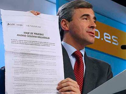 Ángel Acebes muestra un comunicado de Renfe sobre el AVE durante la rueda de prensa de ayer.