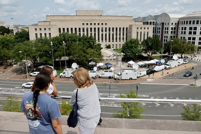 Tourists atop the National Gallery of Art look out over the news trucks in front of the federal courthouse where former U.S. President and Republican presidential candidate Donald Trump is expected to answer charges after a grand jury returned an indictment of Trump in the special counsel's investigation of efforts to overturn his 2020 election defeat In Washington, U.S. August 2, 2023.