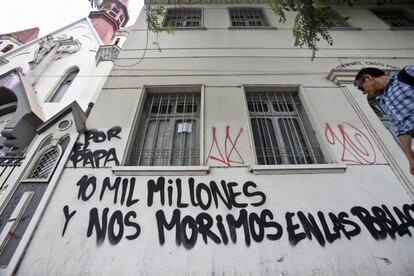 Un grafiti en una iglesia se lee: "10.000 millones por el Papa y nos morimos en las poblaciones".