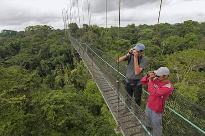 Dos visitantes en un puente suspendido de la reserva Sacha Lodge, en la selva amazónica de Ecuador.