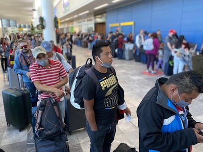 Passengers stand in line at Tijuana International Airport, on December 25, 2022.