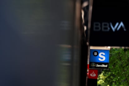 El logotipo de BBVA, Banco Sabadell y Santander, en una misma calle de Madrid.