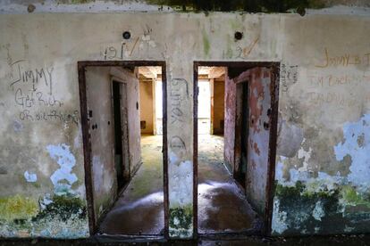 Entrada a dos de las habitaciones del antiguo Hotel Ducor en Monrovia, Liberia, el 1 de octubre de 2017. El hotel Ducor fue en su día el más prominente de África. Construido en el punto más elevado de Monrovia por el israelí Moshe Mayer en 1960, cerró sus puertas 29 años después tras haber sido el primer establecimiento hotelero de 5 estrellas en el continente. Frecuentado por políticos, diplomáticos y empresarios de toda África y extranjero, fue un ejemplo de los años prósperos que vivió en aquella época la África occidental. Sus instalaciones acogieron numerosas reuniones entre líderes africanos y numerosas anécdotas envuelven su historia, como una del dictador ugandés Idi Amin, de quien se dice que se zambulló en su piscina con pistola incluida. El Ducor fue usado tamibén como posicionamiento de tiro por los compatientes del ex presidente liberiano Charles Taylor durante el sitio de Monrovia por las fuerzas rebeldes en 2003. Desde entonces, una espesa vegetación rodea cada uno de los rincones de este edificio desértico de estilo art déco.