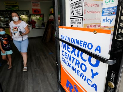 Una mujer sale de una tienda que ofrece servicios para enviar remesas a México y Centroamérica