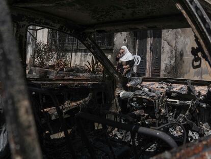 A Palestinian woman sits outside her torched home, days after it was set on fire by Jewish settlers, in the West Bank town of Turmus Ayya, Saturday, June 24, 2023.