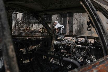 A Palestinian woman sits outside her torched home, days after it was set on fire by Jewish settlers, in the West Bank town of Turmus Ayya, Saturday, June 24, 2023.