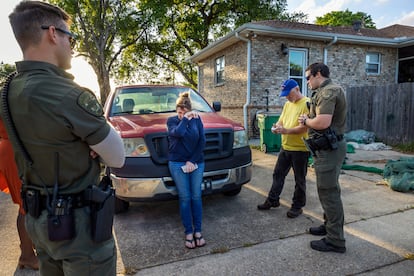 Myra Lacoste, center, wipes away tears as she and her husband, Denny, are asked by state wildlife agents on Thursday, March 16, 2023, to turn in their pet nutria, Neuty, who they rescued after finding it struggling to walk near their home in Bucktown, La.