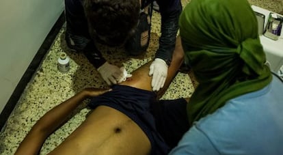 An injured protestor who was shot by Venezuelan security forces on March 30 is given medical assistance.