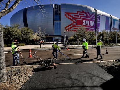 Workers prepare for the NFL Super Bowl LVII football game outside State Farm Stadium, Thursday, Feb. 2, 2023, in Glendale, Ariz.